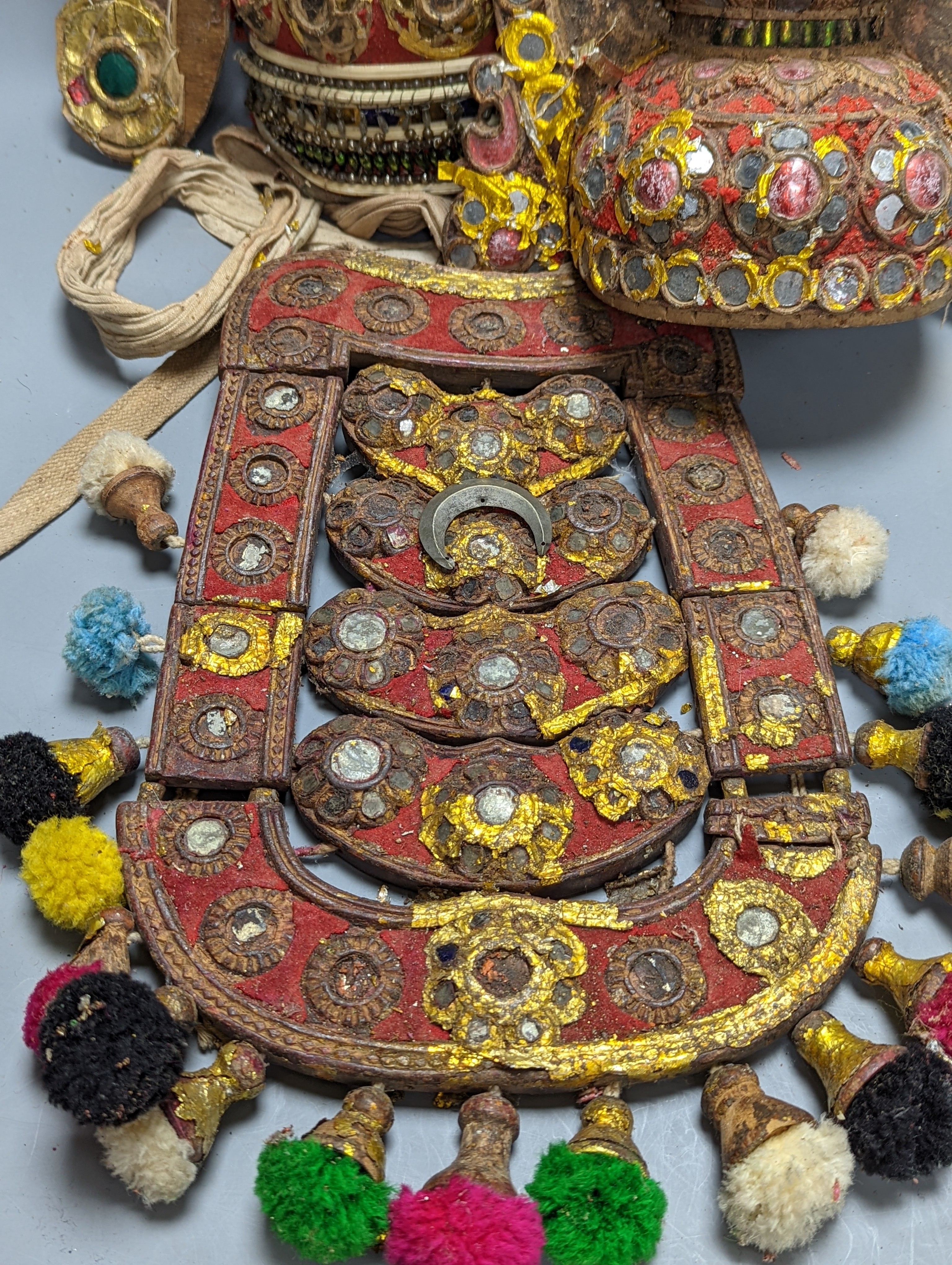 A group of Indian ornate wooden headdresses, masks etc